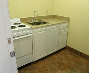 a kitchen with a white stove and a sink at Matador Motel in San Antonio