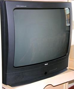 a black tv sitting on top of a table at Matador Motel in San Antonio