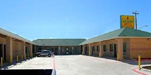 a car parked in a parking lot in front of a motel at Matador Motel in San Antonio