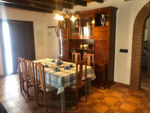 a dining room with a table and some chairs at Casa Olivia in Cómpeta