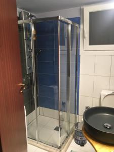 a glass shower in a bathroom with a sink at Joges 2 in Athens