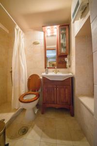 a bathroom with a toilet and a sink and a tub at ARCHANES APPARTMENT in Archanes