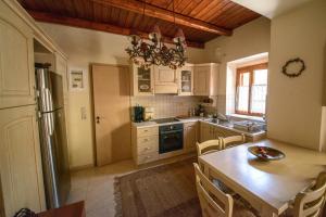 a kitchen with a table and a dining room at ARCHANES APPARTMENT in Archanes