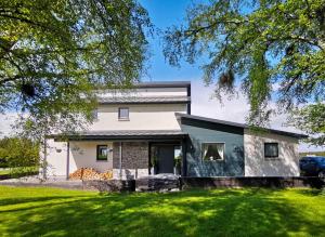 a house with a green lawn in front of it at Beau Rivage in Inverness