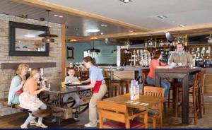 a group of people sitting at tables in a restaurant at Edinburgh, seton sands in Port Seton