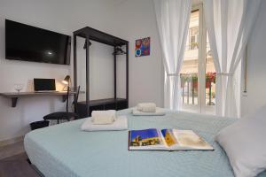 a bedroom with a bed, desk, and television at Better & Better in Palermo