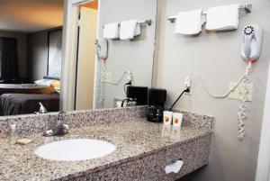 a bathroom with a sink and a mirror at Super 8 by Wyndham Chattanooga Ooltewah in Ooltewah