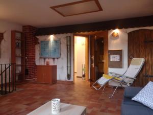 ein Wohnzimmer mit einem Sofa und einem Stuhl in der Unterkunft Ferienhaus Am Park in Löbnitz