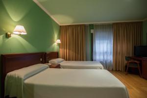 Giường trong phòng chung tại Hotel Villa de Marin