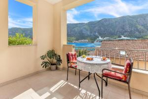 a table and chairs on a balcony with a view at Apartments Castello in Kotor +37 photos