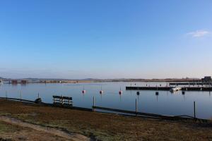 a large body of water with a dock and boats at Haus Ketzenberg 1 - Lütt Mööv in Groß Zicker