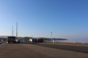a empty street next to a body of water at Haus Ketzenberg 1 - Lütt Mööv in Groß Zicker +10 photos