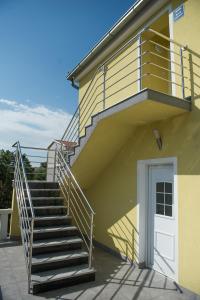 a staircase leading to a building with a white door at Apartment Eleni in Šibenik +9 photos