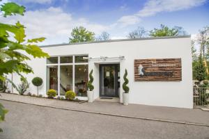 a white building with a sign on it at Haus Sommerhof in Sindelfingen