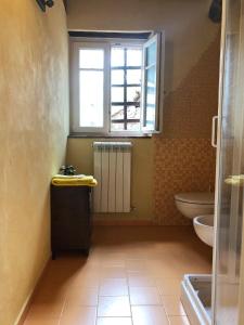uma casa de banho com um lavatório, um WC e uma janela. em Il Capriolo em Lucca