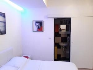 a white room with a bed and a sink at Studio Apartment Vukic in Dubrovnik