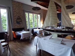 a restaurant with a pirate ship on the wall at Hotel Restaurant Le Bosquet in Les Ponts-de-Cé