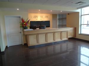 a lobby with a reception desk in a building at Empress Inn and Suites by the Falls in Niagara Falls