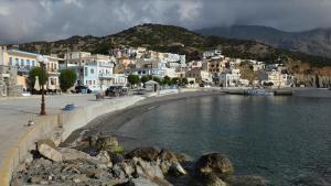 a town with white houses and a body of water at Anesis in Diafani