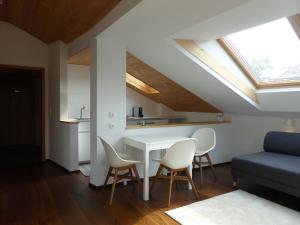 a living room with a white table and chairs at Truchtling Appartements in Seeon-Seebruck