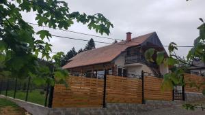 a house with a wooden fence in front of it at Dolce Vita House Vrdnik in Vrdnik