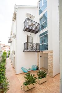 a building with two chairs and a balcony at Villa DiEden in Budva