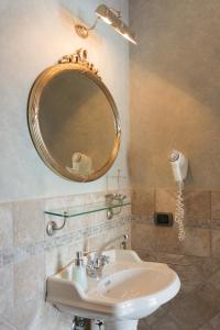 a bathroom with a sink and a mirror at Sunrise Guest House in Maiori