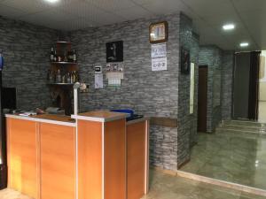 a bar in a room with a brick wall at Hotel Triumph in Ninotsminda