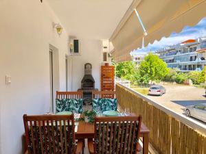 a balcony with a table and chairs and a view of a street at Relax Apartment in Perea