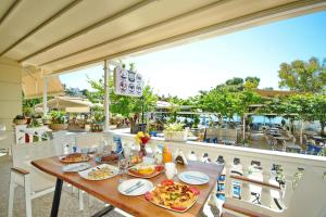 a restaurant with a table with food on it at Galaxy Rooms in Paralio Astros
