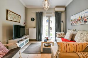 a living room with a couch and a tv at Star Acropolis Apartment in Athens