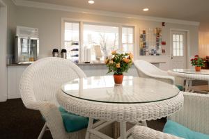a dining room with a glass table and chairs at Auberge on the Cove in Ogunquit