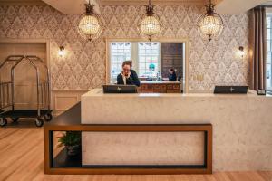 a woman talking on a cell phone in a lobby at The Stella Hotel & Ballroom in Kenosha