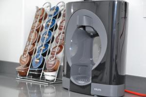 a coffee maker next to a rack of shoes at TERUEL CON AMOR in Teruel