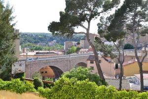 a stone bridge over a city with trees and buildings at TERUEL CON AMOR in Teruel
