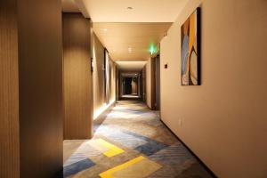 a hallway with yellow and blue tiles on the floor at Hampton By Hilton Hangzhou Future Sign Technology City in Yuhang
