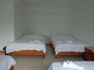 Tempat tidur dalam kamar di Enjoy Hotel