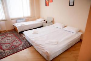 two twin beds in a room with a rug at MINI- VENICE Apartment 2 Bedrooms in Baku +7 photos