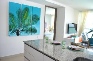 a kitchen with a palm tree painting on the wall at Luxury Alojamientos Namaste-Morros City in Cartagena de Indias