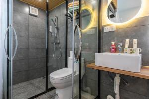 uma casa de banho com um chuveiro, um WC e um lavatório. em U shore house em Quanzhou
