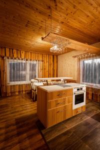 a kitchen with a stove top oven in a room at Wellness Chalet Harmonia in Hriňová