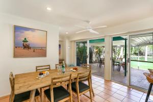 a dining room with a table and views of the beach at Clouds End in Noosaville