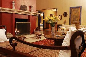 a living room with a couch and a fireplace at Hotel Fazenda Santa Marina in Santana dos Montes