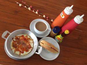 una mesa con una olla de comida y una taza de café en บีที แกรนด์ คอนโดเทล en Udon Thani