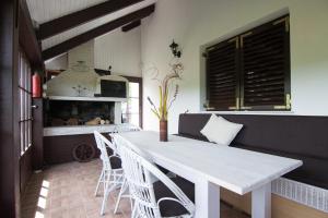 a dining room with a white table and chairs at Residence Green Pool & SPA in Visoko