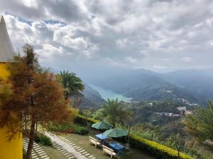 a view from a house with a table and umbrella at Cingjing Brilliant Twins of Seattle in Ren'ai