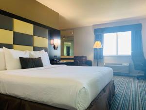 a hotel room with a large bed and a window at SureStay Plus Hotel by Best Western Redding in Redding +10 photos