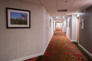 a long hallway with a red carpet on the floor at Empeiria High Sierra Hotel in Mammoth Lakes