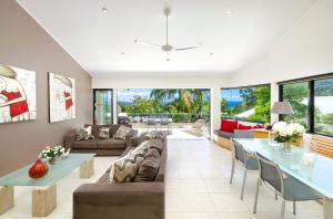 a living room with a couch and a table at A Little Cove treasure, Noosa Heads in Noosa Heads