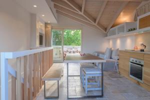 a kitchen and living room with a table and chairs at Carpofoli Corfu Town Serviced Luxury Suites in Corfu